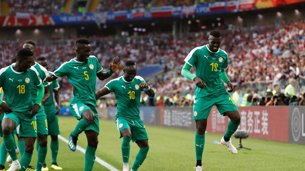 Senegal’s Mbaye Niang dances in celebration with his teammates after scoring his side’s second goal during the Group H match between Poland and Senegal