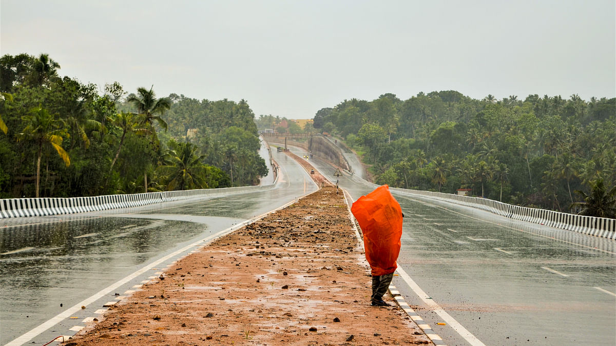 A worker stands on the newly constructed NH Bypass Road in Thiruvananthapuram, Kerala