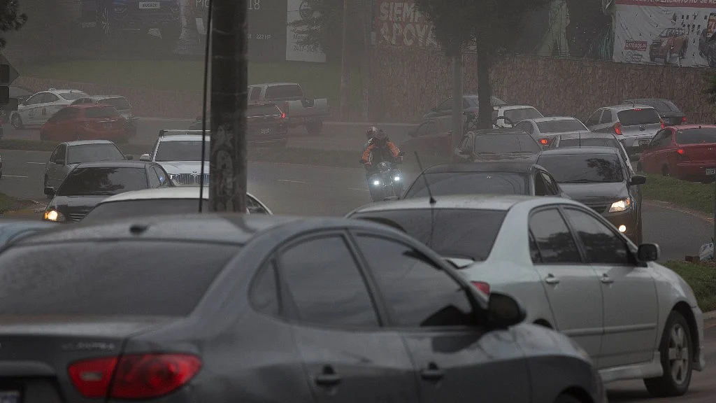 Drivers make their way through a light rain of volcanic ash, as the Volcan de Fuego erupts, in Guatemala City on Sunday, 3 June. 