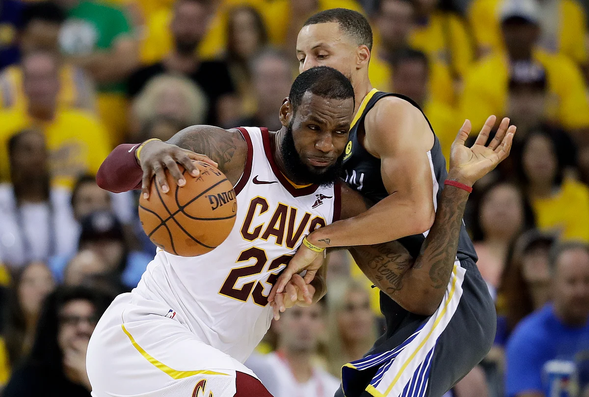 Cleveland Cavaliers forward LeBron James (23) drives against Golden State Warriors guard Stephen Curry during the first half of Game 2 of basketball’s NBA Finals.