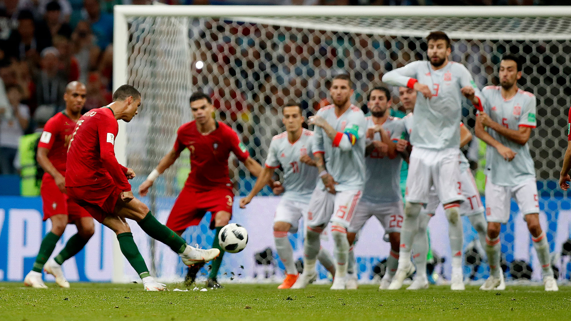 Portugal’s Cristiano Ronaldo, left, scores his side’s equalizing goal during the group B match between Portugal and Spain at the 2018 soccer World Cup in the Fisht Stadium in Sochi, Russia, Friday, June 15, 2018.