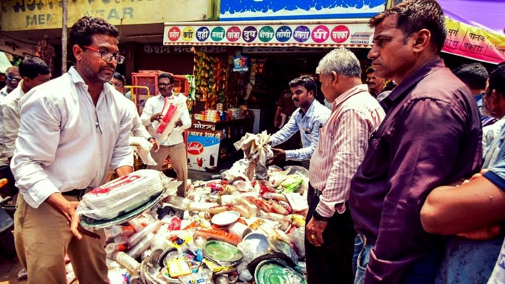 Nagpur Municipal Corporation (NMC) worker seize plastic material at a shop during an inspection following a plastic ban, in Nagpur on Saturday, June 23, 2018.