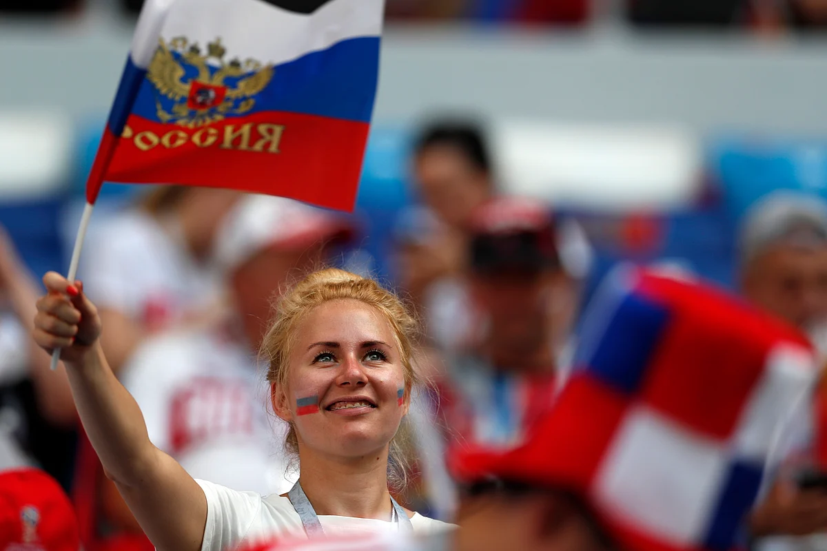 A fan waves a Russian flag ahead of the group A match between Uruguay and Russia at the FIFA World Cup 2018