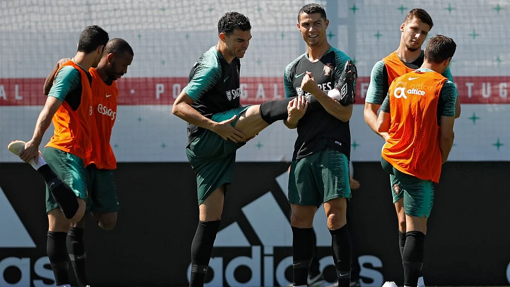Portugal’s Cristiano Ronaldo (right) stretches with teammate Pepe during their training session in Kratovo in the outskirts Moscow on Sunday.