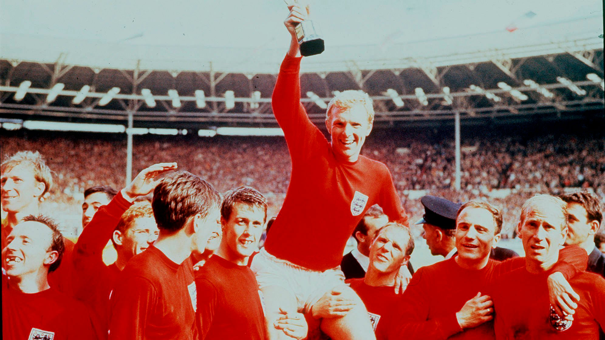 In this July 30 1966 file photo, England’s soccer captain Bobby Moore, carried shoulder high by his teammates, holds aloft the Jules Rimet Trophy. England defeated Germany 4-2 in the final of the 1966 World Cup at London’s Wembley Stadium.&nbsp;