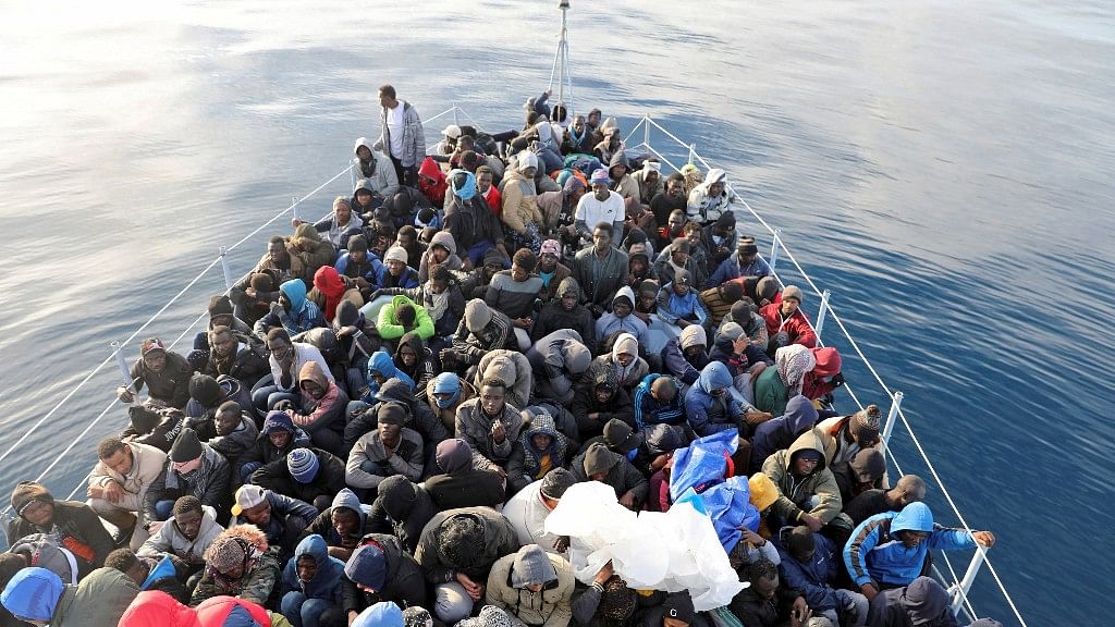 Migrants are seen in a boat as they are rescued by Libyan coast guards in the Mediterranean Sea.