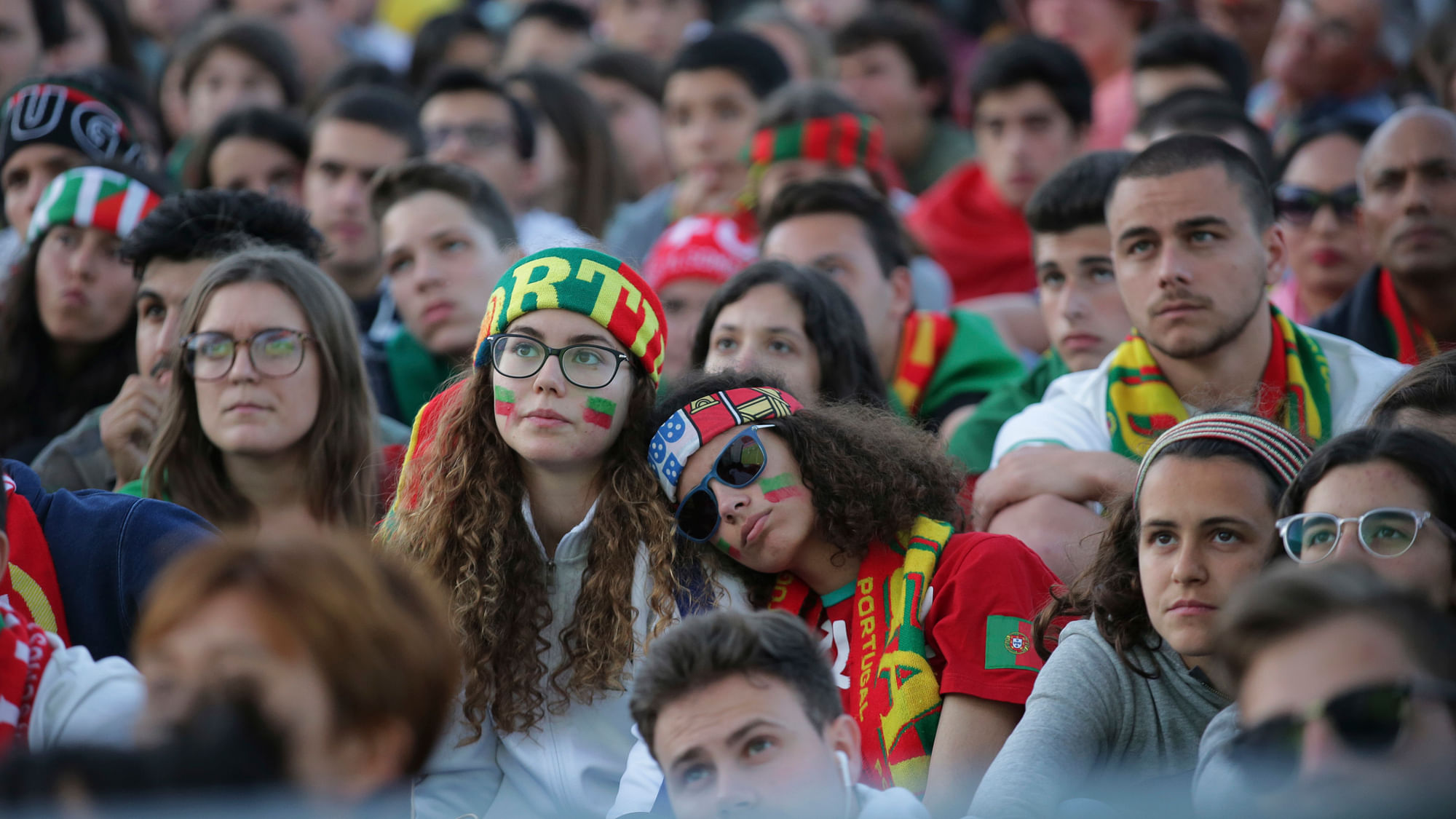 Portugal fans watch the 2018 soccer World Cup group B match between Portugal and Spain being shown on a video screen in Lisbon’s Comercio square, Friday, June 15 2018.&nbsp;