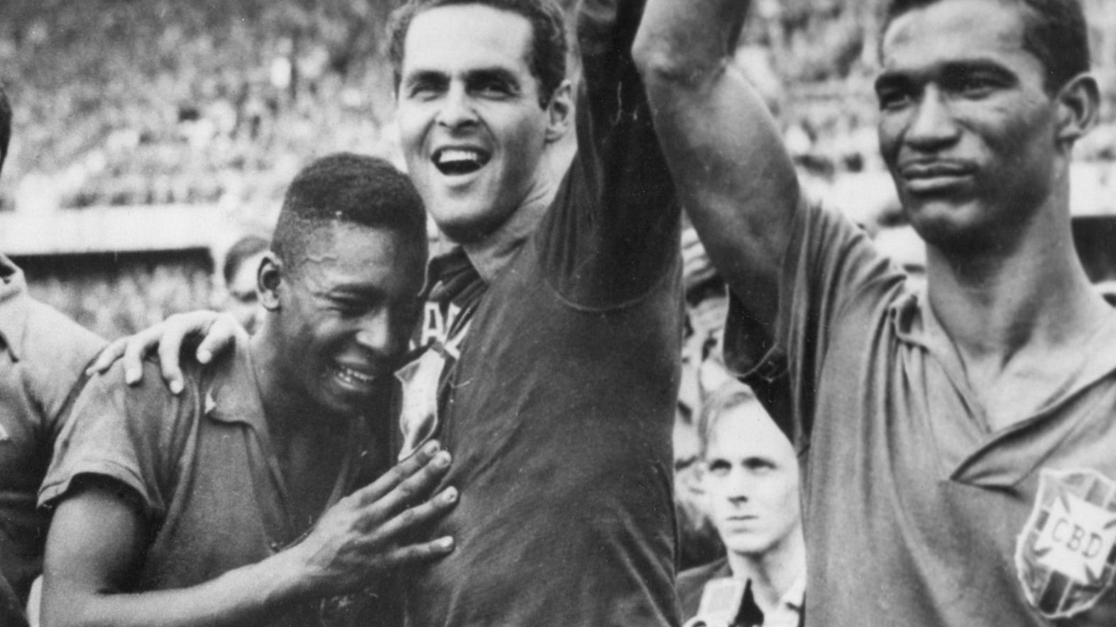 In this June 29, 1958 file photo Brazil’s 17-year-old Pele, left, weeps on the shoulder of goalkeeper Gilmar Dos Santos Neves, after Brazil’s 5-2 victory over Sweden in the World Cup final soccer match, in Stockholm, Sweden. Brazil’s Didi is at right. Pele scored twice in that final.&nbsp;