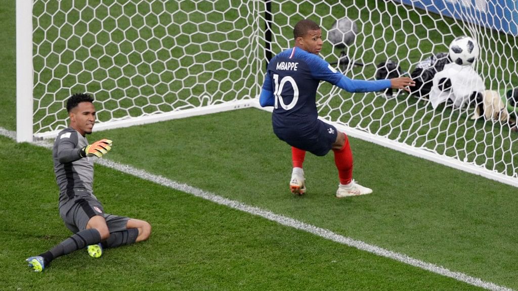 France’s Kylian Mbappe (right) scores the opening goal past Peru goalkeeper Pedro Gallese during the Group C at the Yekaterinburg Arena on Thursday.