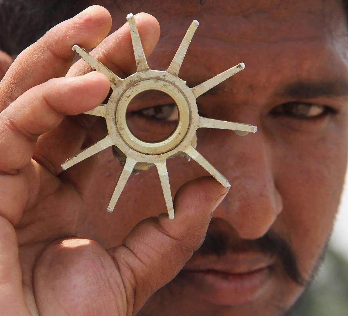 A villager shows the tail of a mortar shell after firing from the Pakistani side at Kanachak village, about 35km from Jammu on Sunday, 3 June. 