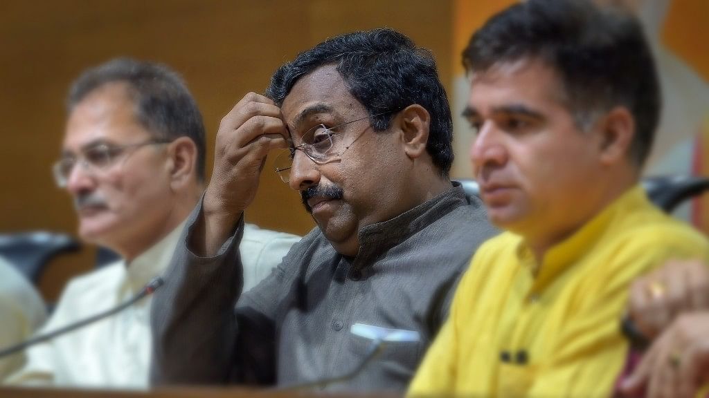 BJP in-charge for Jammu and Kashmir Ram Madhav, flanked by the state former Dy CM Kavinder Gupta (L) and BJP state chief Ravinder Raina (R).