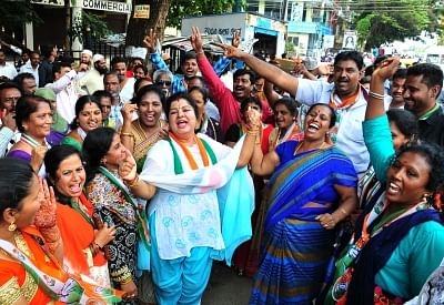 Bengaluru: Congress workers celebrate after Congress candidate Muniratna won Rajarajeshwari Nagar assembly seats in the bypoll; in Bengaluru on May 31, 2018. (Photo: IANS)