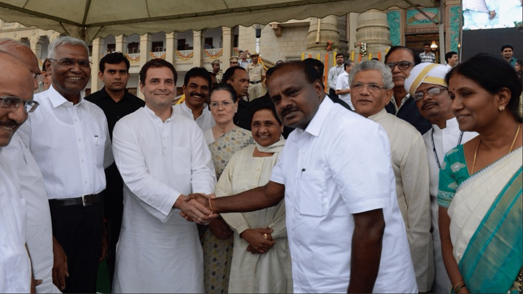 Rahul Gandhi clasps hands with new Karnataka Chief Minister HD Kumaraswamy.