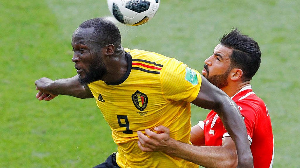 Belgium’s Romelu Lukaku, left, and Tunisia’s Yassine Meriah fight for the ball.