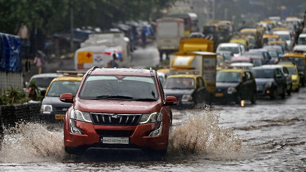 Vehicles wade through water-logged tracks during heavy rains in Mumbai.