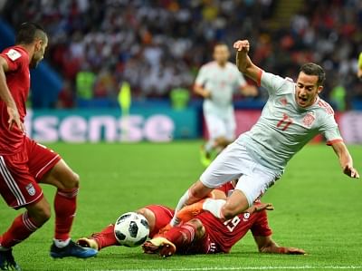 KAZAN, June 20, 2018 (Xinhua) -- Lucas Vazquez (top) of Spain vies with Majid Hosseini of Iran during a Group B match between Spain and Iran at the 2018 FIFA World Cup in Kazan, Russia, June 20, 2018. Spain won 1-0. (Xinhua/Liu Dawei/IANS)