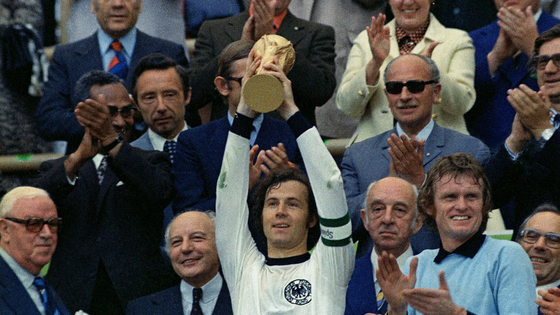 Franz Beckenbauer lifts the FIFA World Cup trophy as captain of the winning West Germany team in 1974.