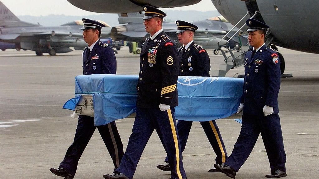 In this September 2000, file photo, United Nations’ soldiers carries a coffin of US soldier’s remains upon arrival at Yokota airbase in Tokyo.