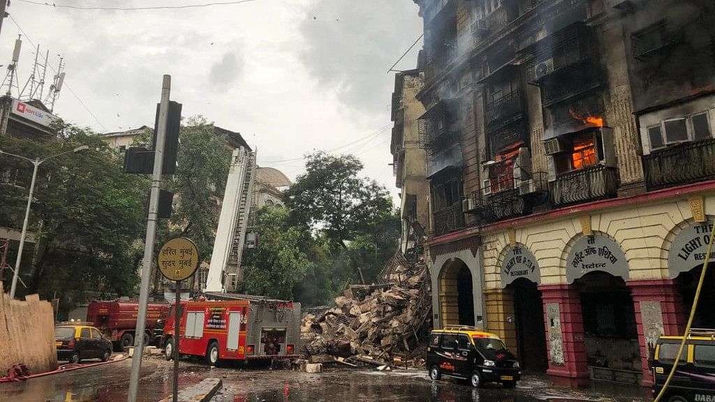 Firefighters extinguish a blaze that caused Kothari building in Mumbai to partially collapse.