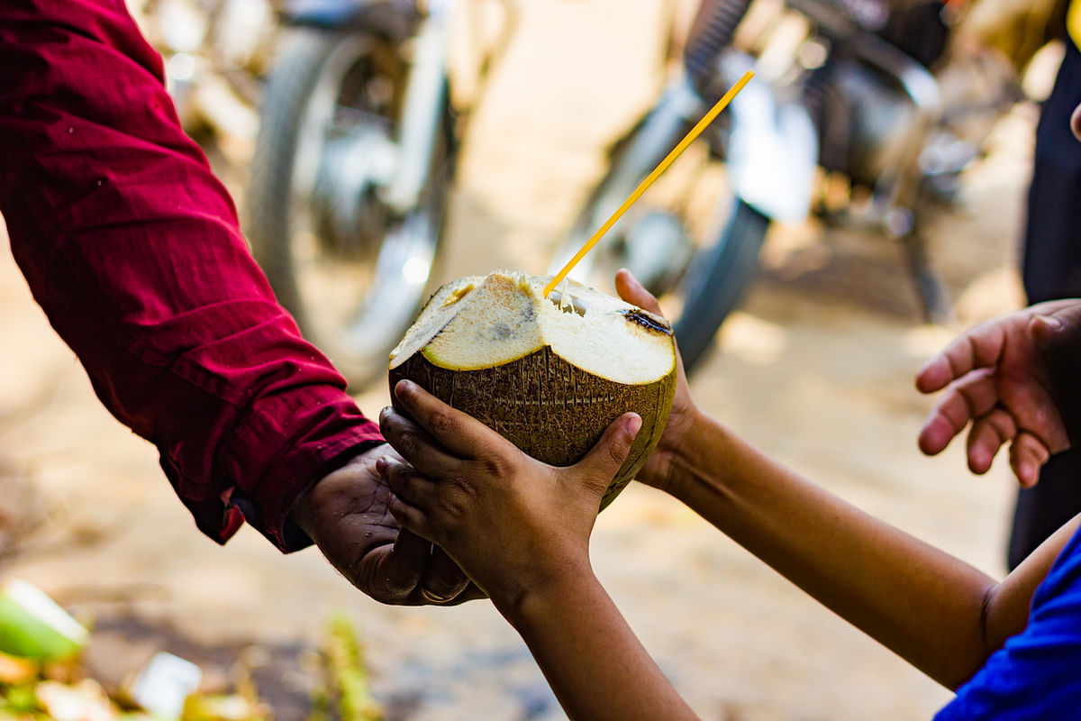 The coconut vendor’s bell would call out to everyone, and while we discussed temperatures, orders would be placed.
