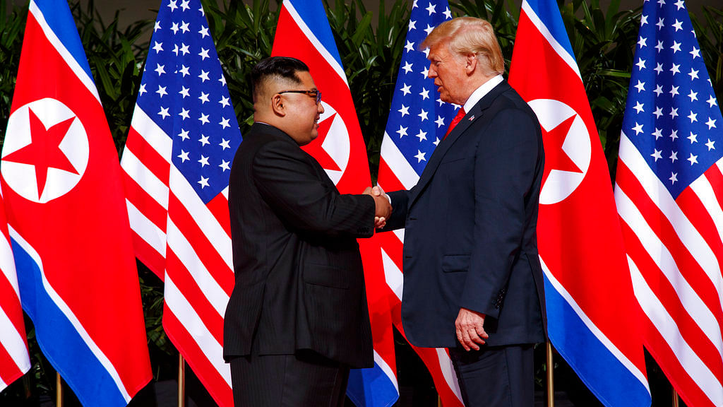 Donald Trump and Kim Jong Un shake hands with each other at the Singapore summit.