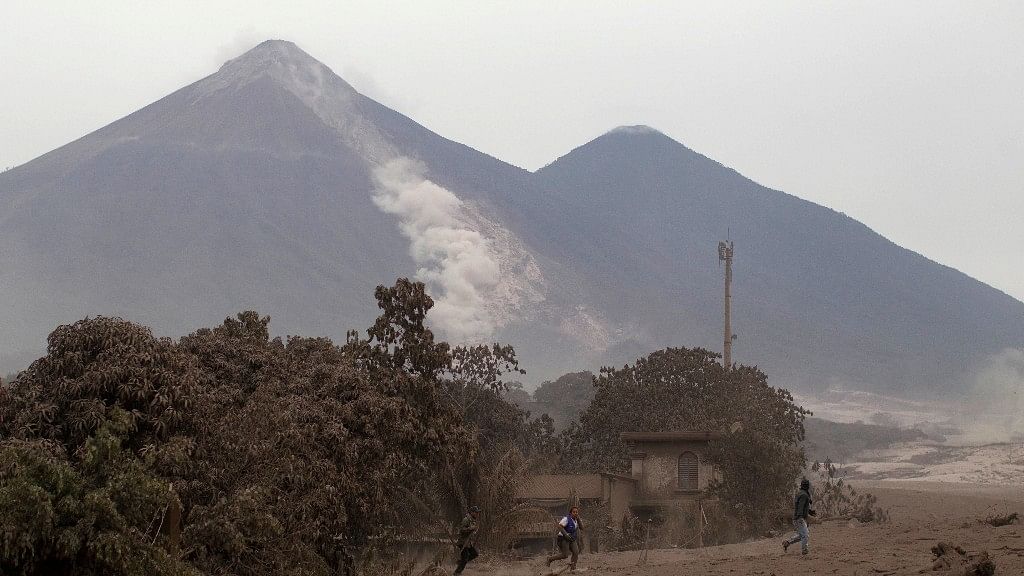 The Volcan de Fuego, or Volcano of Fire, continues to spill out smoke and ash as residents evacuate Escuintla, Guatemala, Monday, 4 June.