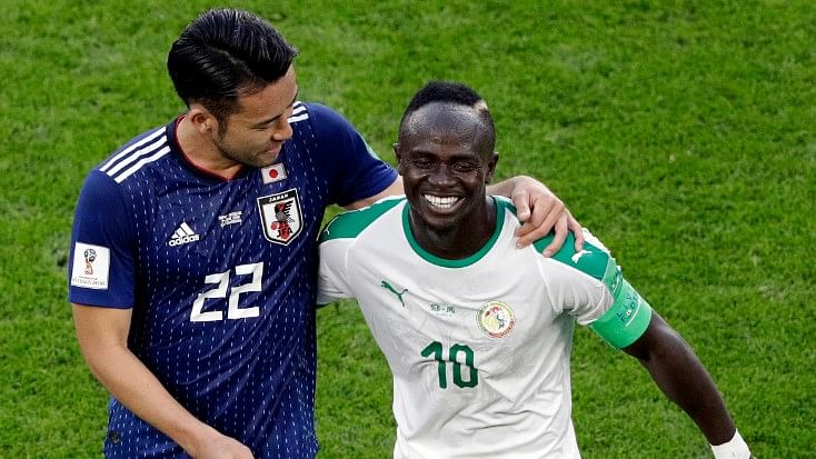 Japan’s Maya Yoshida (left) shares a light moment with Senegal’s Sadio Mane after their Group H  at the Yekaterinburg Arena on Sunday.