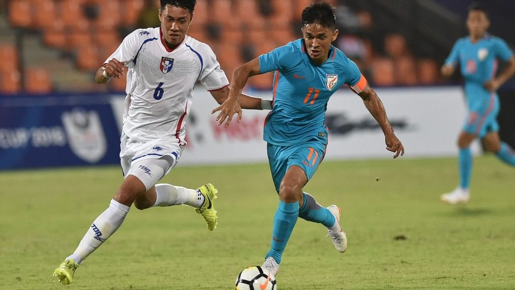 Sunil Chhetri  and Chinese Taipei player Wei-Chuan Chen  vie for the ball during the Hero Intercontinental  football Cup in Mumbai on Friday.