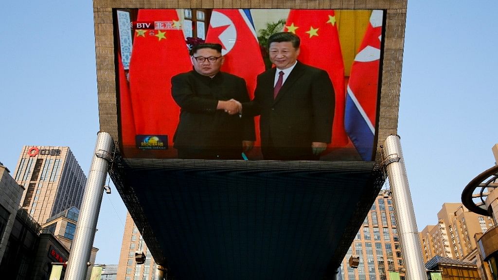 A giant TV screen broadcasting the meeting of North Korean leader Kim Jong Un and Chinese President Xi Jinping during a welcome ceremony at the Great Hall of the People in Beijing, Tuesday, 19 June, 2018.