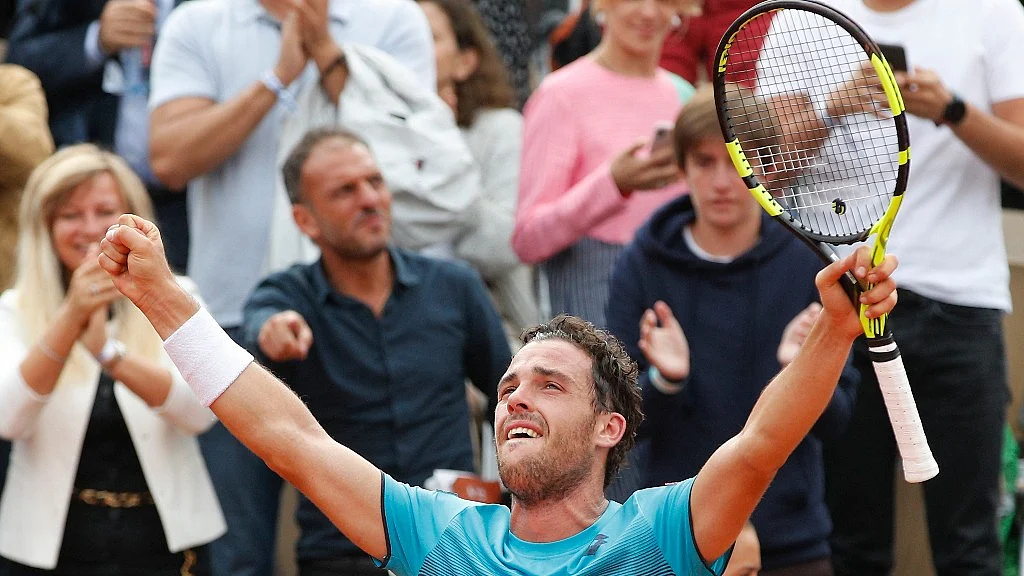 Italy’s Marco Cecchinato celebrates after winning his quarterfinal match in the French Open against Novak Djokovic in four sets 6-3, 7-6 (7-4), 1-6, 7-6 (13-11) at the Roland Garros in Paris on Tuesday.