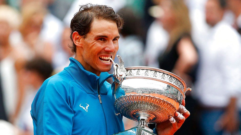 Rafael Nadal poses with the French Open trophy for the eleventh time.