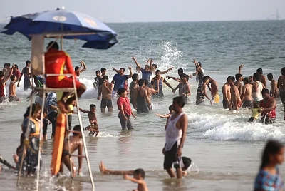 Goa: Domestic tourists enjoy summer vacations at Calangute beach of Goa. (Photo: IANS)