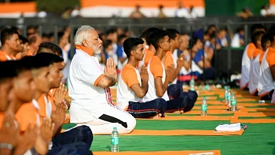 Dehradun: Prime Minister Narendra Modi practices yoga asanas (postures) on the Fourth International Yoga Day at Forest Research Institute (FRI) in Dehradun on June 21, 2018. (Photo: IANS/PIB)