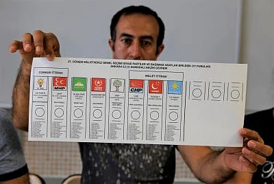 ANKARA, June 24, 2018 (Xinhua) -- A worker shows the ballot of parliamentary election at a polling station in Ankara June 24, 2018. Turkey held presidential and parliamentary elections on Sunday. (Xinhua/Qin Yanyang/IANS)
