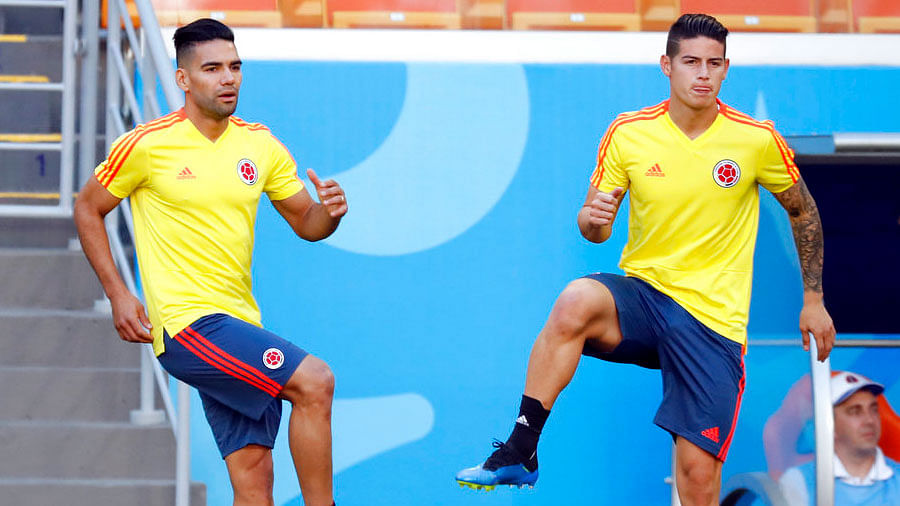 Colombia’s James Rodriguez, right, and Radamel Falcao, left, warm up during a practice session.