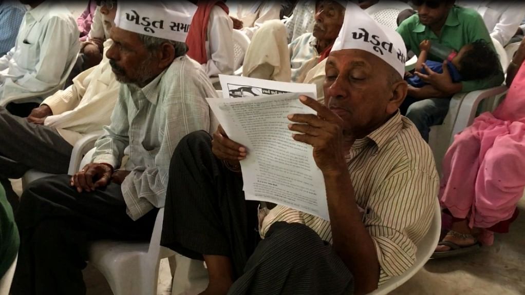 A farmer keenly reads the prospectus of the meeting called Gujarat Khedut Samaj at Chaklashi Nadiad