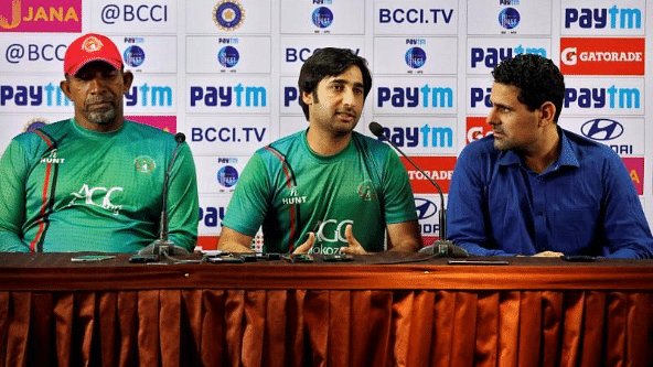 Coach Phil Simmons (left) and Captain Asghar Stanikzai (centre) at a press conference prior to the start of the Test match against India.