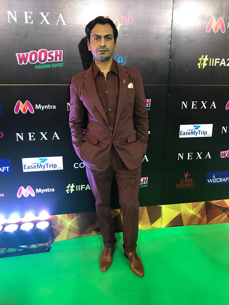 Nawazuddin Siddique chooses a maroon suit and brown shoes for the event. 