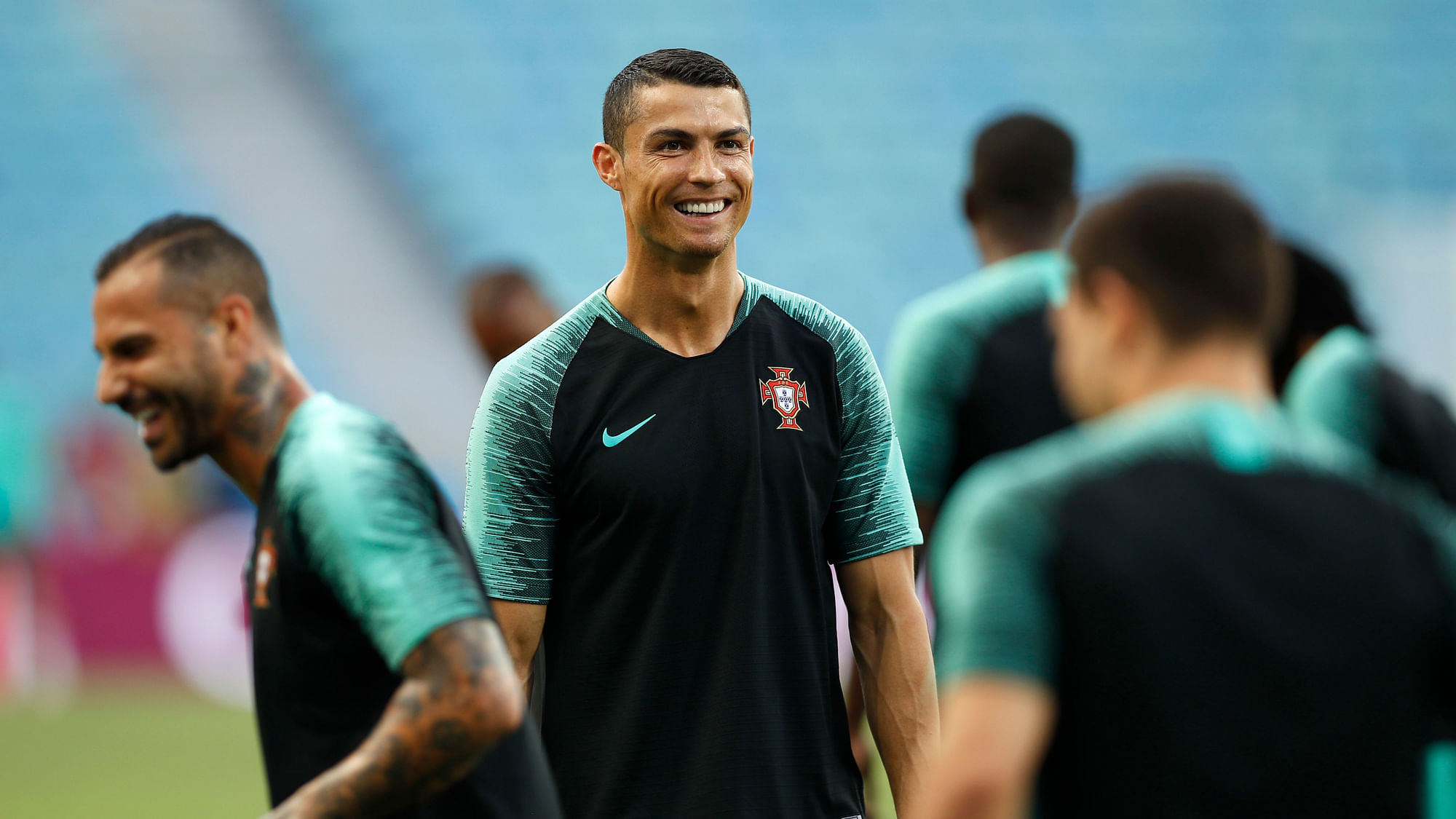 Portugal’s Cristiano Ronaldo, centre, smiles during Portugal’s official training on the eve of the group B match between Portugal and Spain.