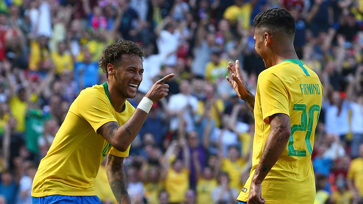 Brazil’s Roberto Firmino, right, celebrates with team mate Neymar after scoring his side’s second goal.
