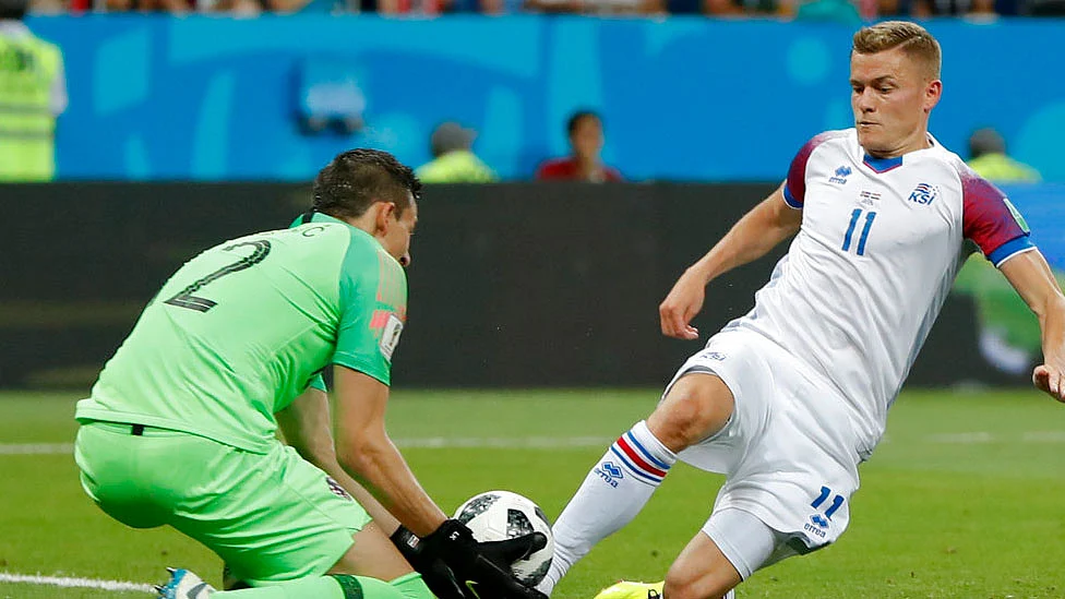 Croatia goalkeeper Lovre Kalinic, left, and Iceland’s Alfred Finnbogason fight for the ball during their group match. 