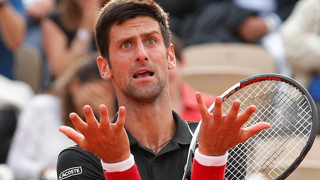 Novak Djokovic reacts after missing a shot against Italy’s Marco Cecchinato in t fourth set of their quarterfinal match at the French Open at the Roland Garros in Paris on Tuesday.