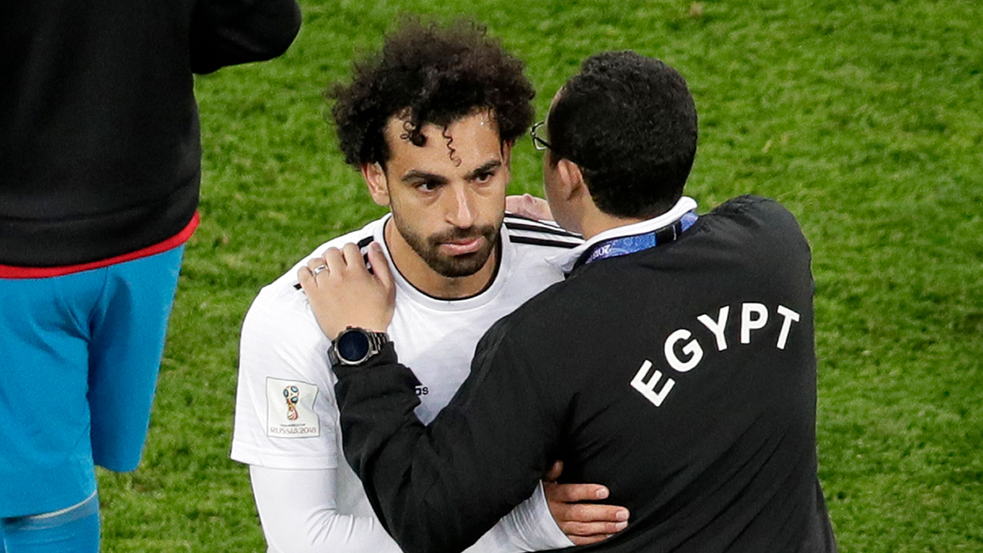 A Egypt’s team official comforts Egypt’s Mohamed Salah after the group A match between Russia and Egypt at the 2018 soccer World Cup in the St. Petersburg stadium in St. Petersburg, Russia, Tuesday, June 19, 2018.