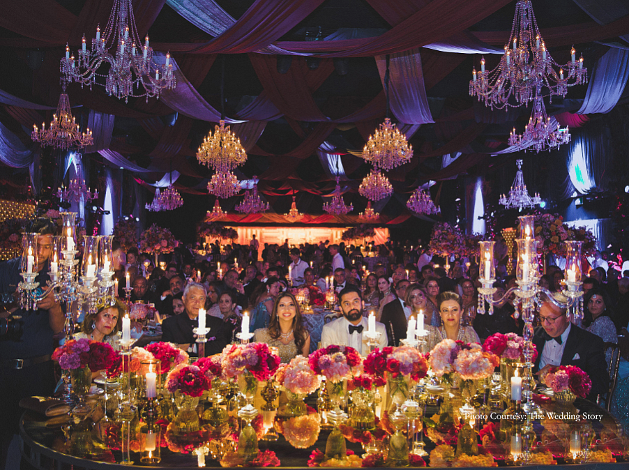 The decor was complete with gorgeous floral arrangements, exquisite drapes and a large stage with an LED backdrop displaying the couple’s initials monogrammed.