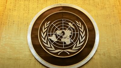 Plaque bearing the United Nations logo above the podium of the General Assembly Hall.