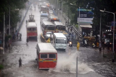 Mumbai: Vehicles move through the flooded Dadar TT Circle during heavy rains, in Mumbai on July 10, 2018. (Photo: IANS)