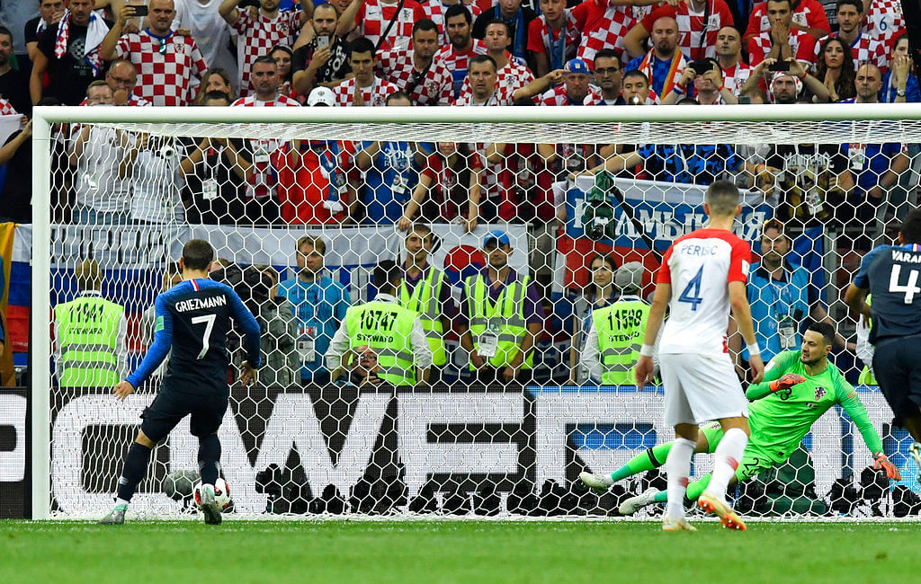 Antoine Griezmann (number 7) calmly slots a 38th minute penalty into the net