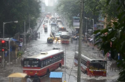 Mumbai: Vehicles move through the flooded Dadar TT Circle during heavy rains, in Mumbai on July 10, 2018. (Photo: IANS)