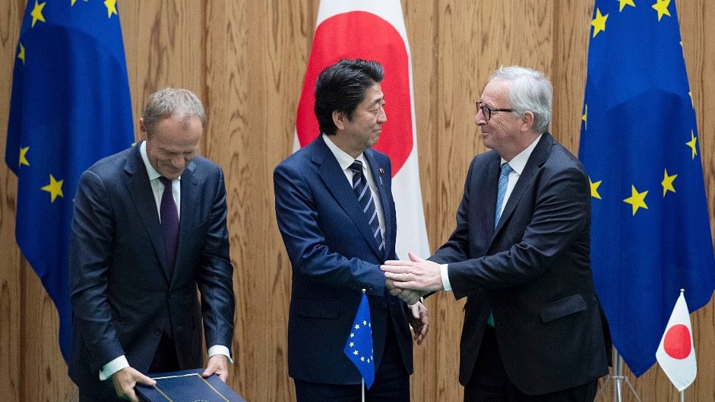 Japanese Prime Minister Shinzo Abe shakes hands with European Union’s Commission President Jean-Claude Junker after signing a contract at the prime minister’s office in Tokyo.