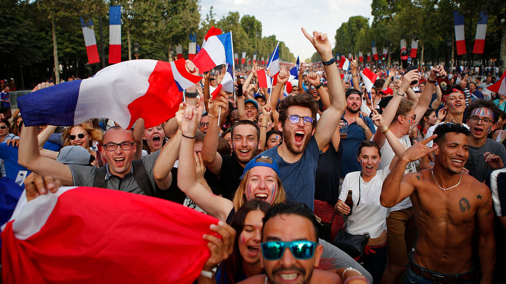 People celebrate on the Champs Elysees avenue after France won the soccer World Cup final match between France and Croatia.